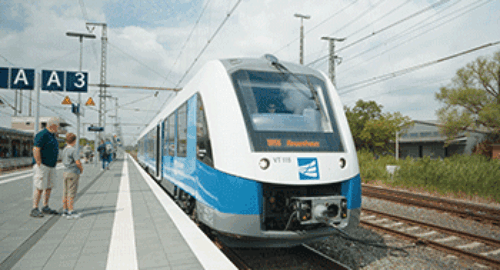 Fahrgäste warten auf dem Bahnsteig auf die Einfahrt eines Regionalzuges der Bentheimer Eisenbahn AG